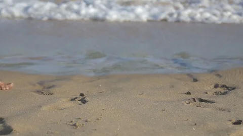 People walking on the beach in slow motion Stock Footage 128074645
