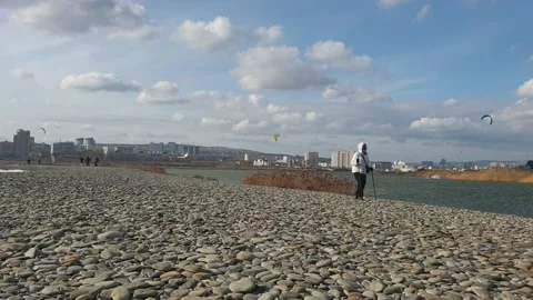 People walking at the beach in stormy weather Stock Footage 149783853
