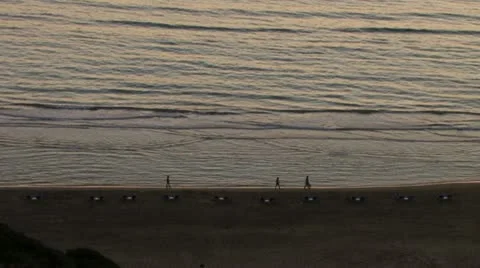 People walking on the beach at sunset Stock Footage 18192323