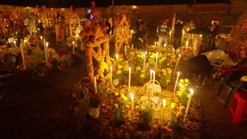PEOPLE WALKING BETWEEN THE GRAVES IN DAY OF THE DEATH 2024 IN MEXICO Stock Footage 317747890