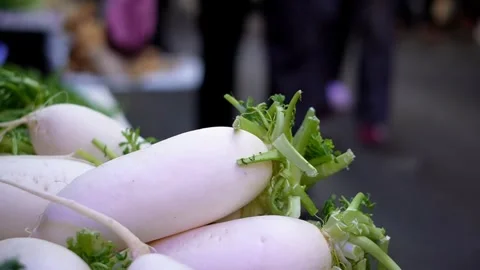 People walking by big White radish in farmer's market, China Stock Footage 334099019