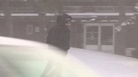 People walking in blizzard snow wind and cold weather in major winter storm Stock Footage 44067742