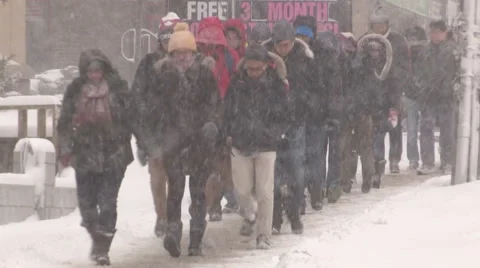People walking in blizzard snow wind and cold weather in major winter storm Stock Footage 44147019