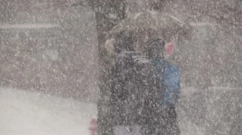 People walking in blizzard snow wind and cold weather in major winter storm Stock Footage 45595521