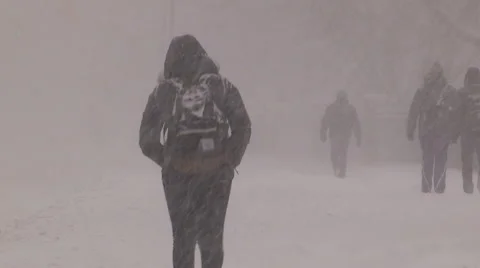People walking in blizzard snow wind and cold weather in major winter storm Stock Footage 45724660