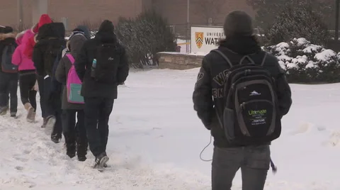People walking in blizzard snow wind and cold weather in major winter storm Stock Footage 45755643