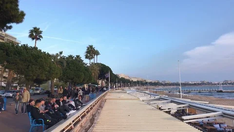 People walking on the Boulevard de la Croisette in Cannes, France Stock Footage 74056728