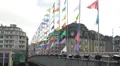 People walking bridge decorated with many colorful banners, festive atmosphere HD Footage