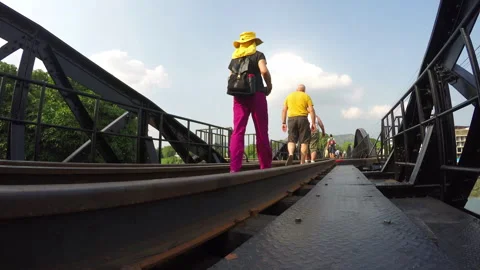 People walking on the bridge over river kwai Stock Footage 282757585
