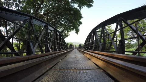 People walking on the bridge over river kwai Stock Footage 283014288