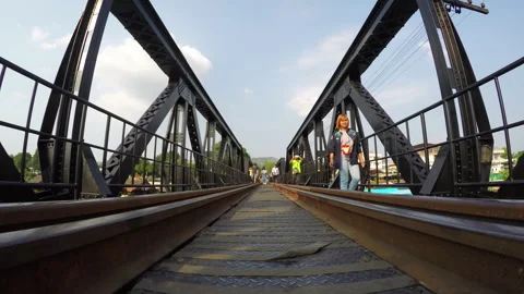 People walking on the bridge over river kwai Stock Footage 283905371