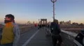 People walking on Brooklyn Bridge New York City at sunset 4k or 4k+ Resolution