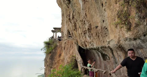 People walking carved path from Dragon Gate at cliff, Western Hills in Kunming Video stock 329460764