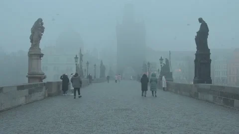 People walking on the Charles Bridge during fog in Prague, Czech Republic. Stock Footage 135540879