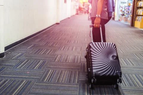 People walking for check in at airport. A man and luggage at the airport term Stock Photos