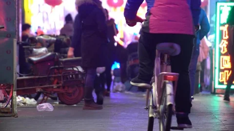 People walking in city at night, China, Shenyang Stock Footage