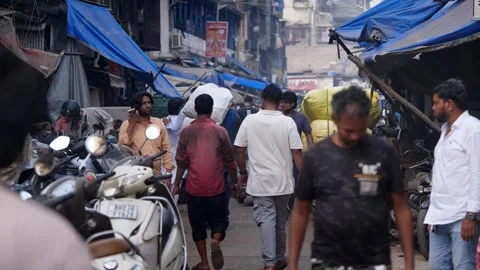 People walking in a congested and crowded wholesale market in downtown Mumbai Stock Footage 329098768