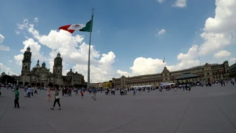 People walking on the Constitution Square with the flag of Mexico waving. Stock Footage 114261464