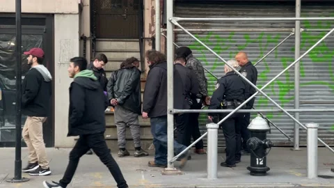 People walking by as cops arrest man on 8th Street Manhattan New York City NYC Stock Footage 232433372