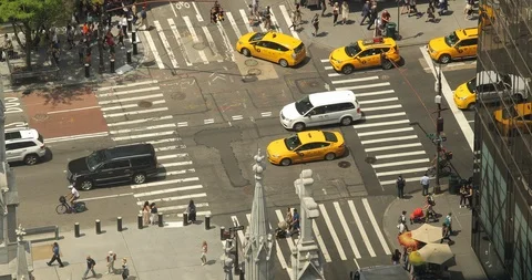 People walking crossing street in New York City vantage view street traffic Stock Footage
