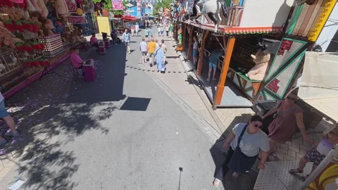 People walking at a crowded amusement park fairground Stock Footage 337955006