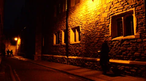 People walking on a dark poorly light street Stock Footage 31914209