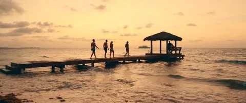 People walking on dock at sunset 動画素材 84331043