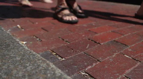 People walking down a brick sidewalk Video stock 66263120