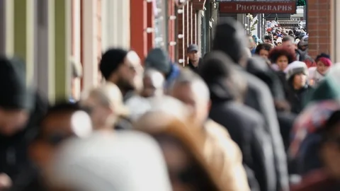 People walking down crowed sidewalk during film festival Stock Footage 85591732