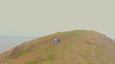 People walking down a hilltop in summer-set Stock Footage 198218823