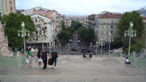 People walking down a long staircase to Marseille Stock Footage 229211160