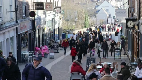 People walking down an old fashioned high street Stock Footage 172543516
