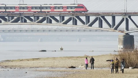 People Walking Down the River Beach. Train is Coming Stock Footage 80287949