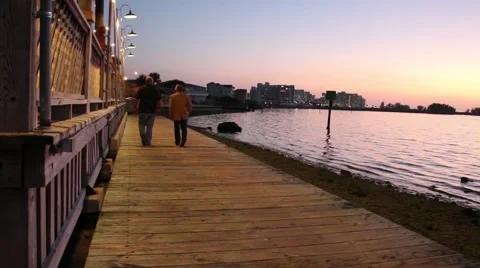 People walking down side of beach bar at dusk Stock-Footage 47548366