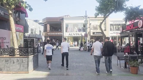 People walking down a sidewalk in a. Stock Footage 282663542