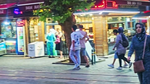 People walking down a sidewalk in a. Stock Footage 282999744