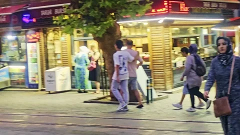 People walking down a sidewalk in a. Stock Footage 284673786