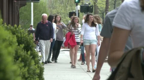 People walking down sidewalk on Main Street (4 of 5) Stock Footage 10568711