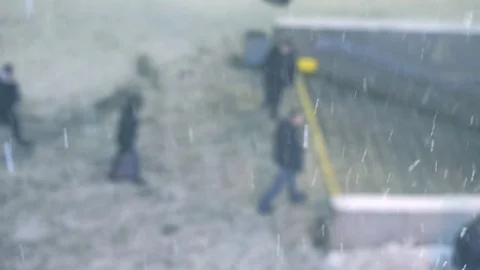 People walking down the sidewalk in the snow. the snowfall Video stock 70178136