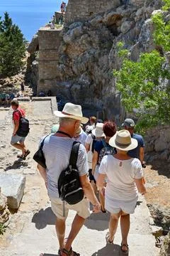 People walking down steps after visiting the acropolis in Lindos Stock Photos