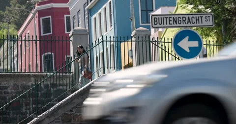 People walking down stone stair to lower path, cars and woman in white dress Stock Footage 337097815