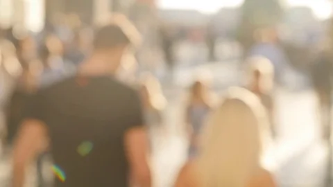 People walking down the street in the evening. Defocus and slow motion Stock Footage
