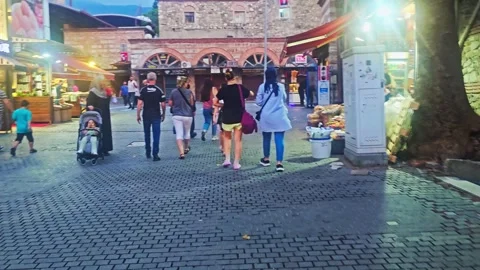 People walking down a street in a. Stock Footage 282999415
