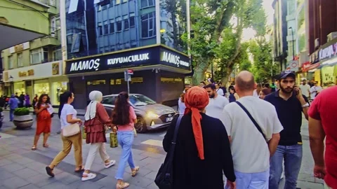 People walking down a street in a. Stock Footage 284057463