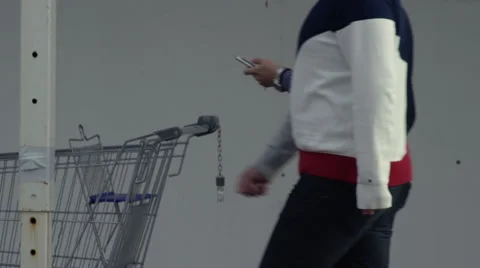 People walking down street using their smart phone Stock Footage 68084680