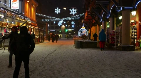 People walking down street while it's snowing in Chamonix Stock Footage 61628947