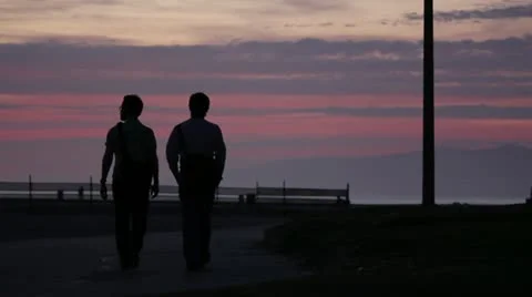 People Walking at Dusk on Beach Stock Footage 11441866