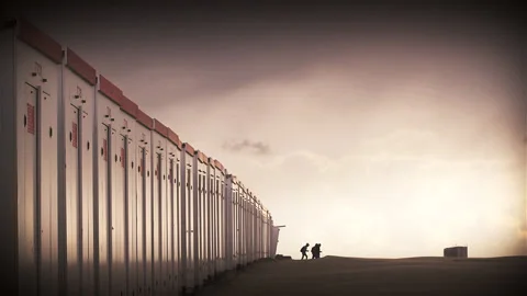 People walking on an empty beach under evening light Stock Footage 89657329