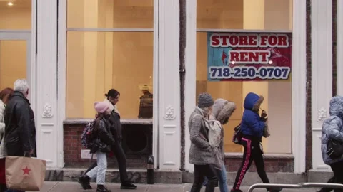 People walking by Empty Storefront Closed due to Covid 19 Pandemic - 60 FPS Stock Footage 229916139