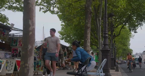 People Walking At The Famous Gallery Boxes Along The Seine River In Paris Stock Footage 211465347